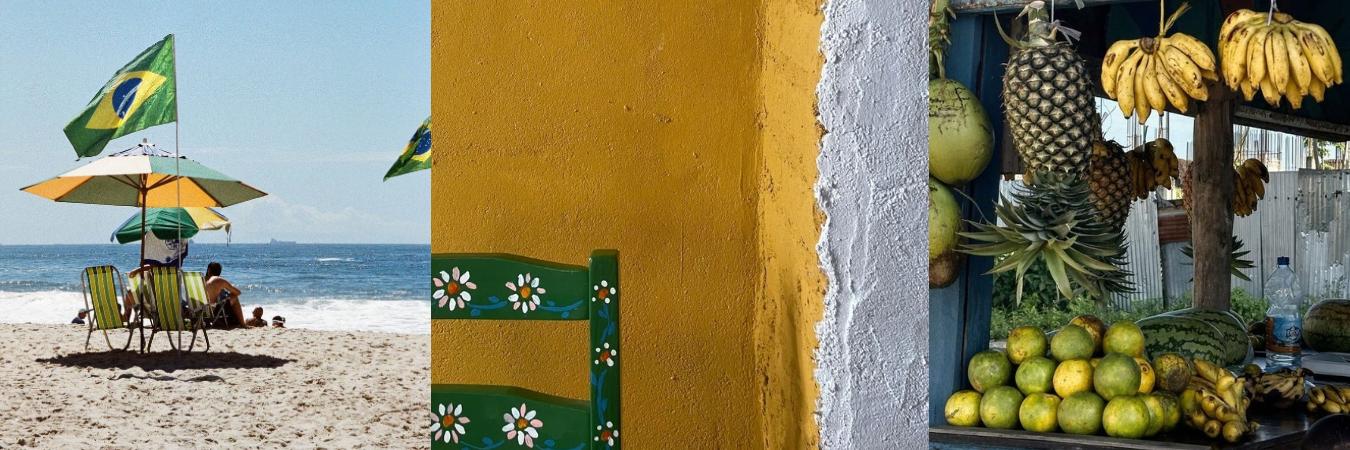 Beach scene with colorful flags, fruit stand, and ocean view.