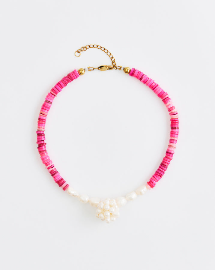 Necklace with pink beads and gold clasp on a white background