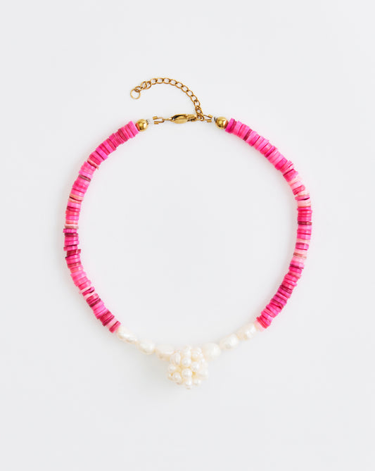 Necklace with pink beads and gold clasp on a white background