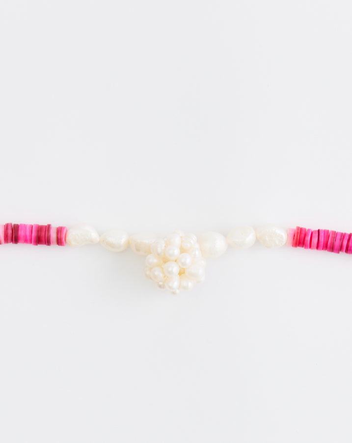 Necklace with pink and white beads on a white background