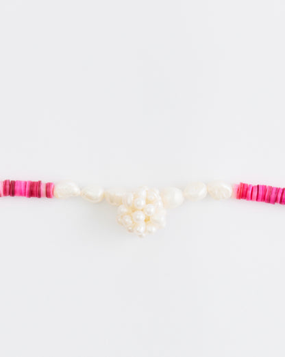 Necklace with pink and white beads on a white background