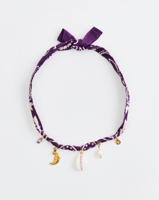 Purple headband with bow and charms on a white background