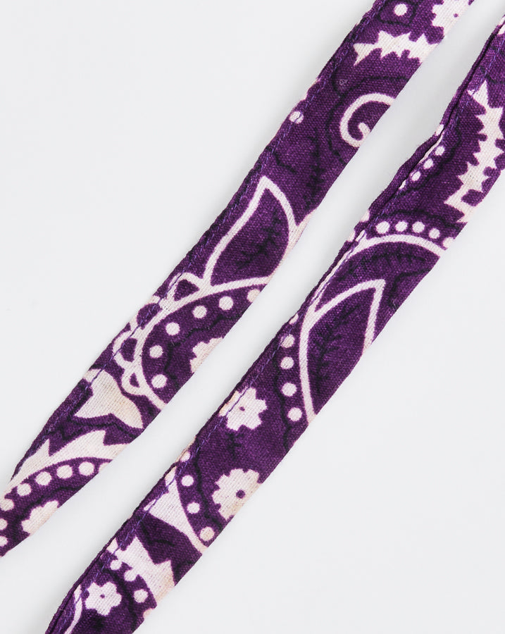 Purple headband with white paisley pattern on a white background