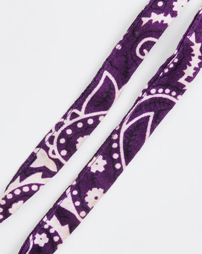 Purple headband with white paisley pattern on a white background