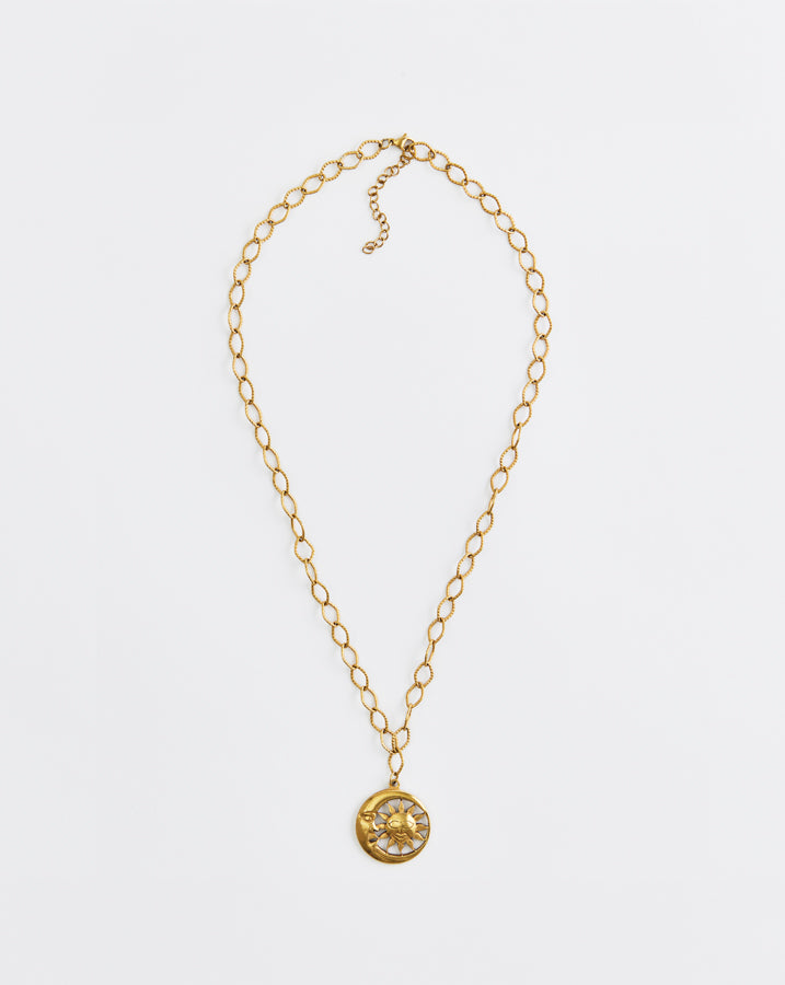 Gold necklace with a pendant on a white background