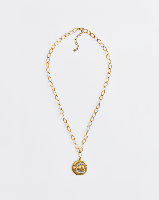 Gold necklace with a pendant on a white background