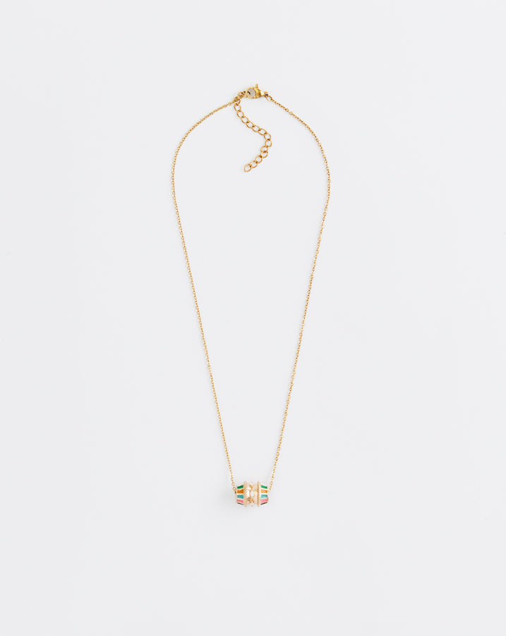 Gold necklace with a small pendant on a light gray background