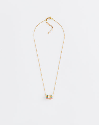 Gold necklace with a small pendant on a light gray background