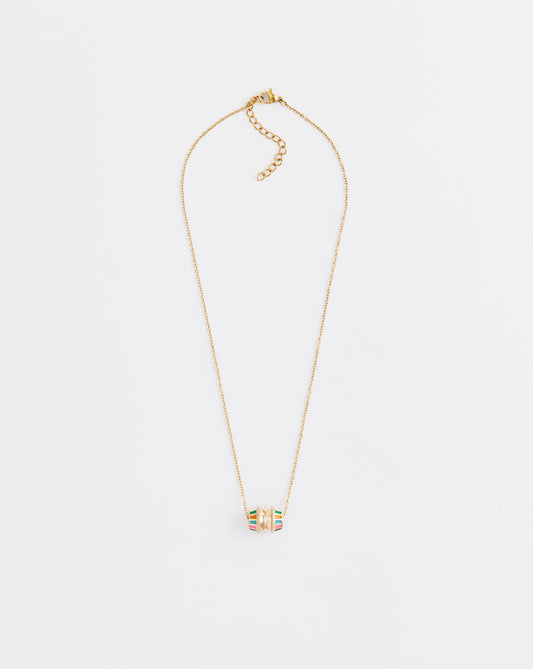 Gold necklace with a small pendant on a light gray background