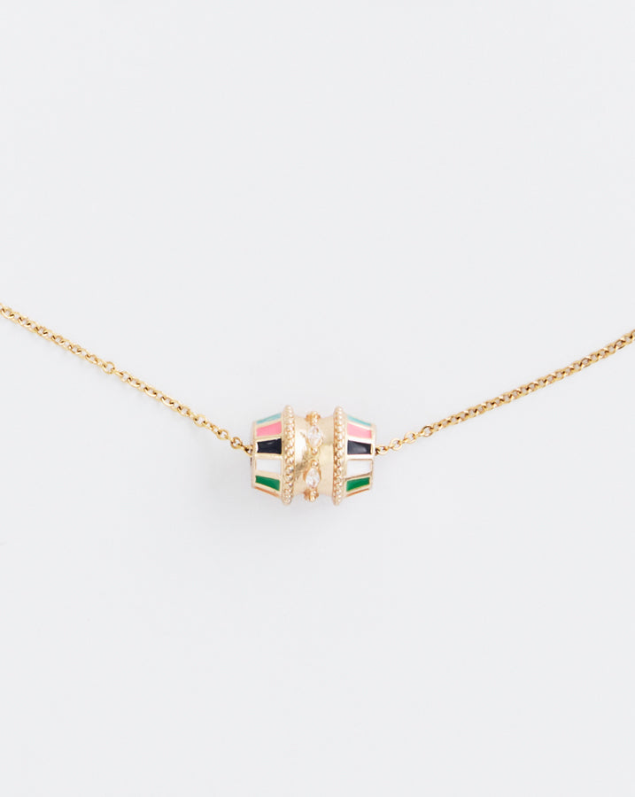 Necklace with a colorful cube pendant on a light beige background