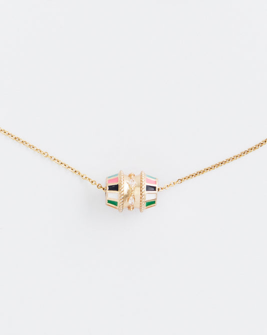 Necklace with a colorful cube pendant on a light beige background