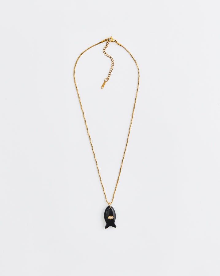 Gold necklace with a black pendant on a white background