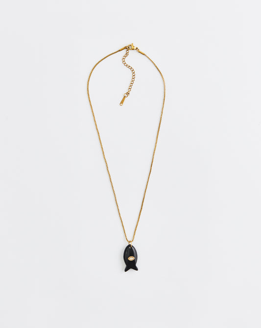 Gold necklace with a black pendant on a white background