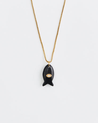 Black pendant necklace with gold chain on a white background