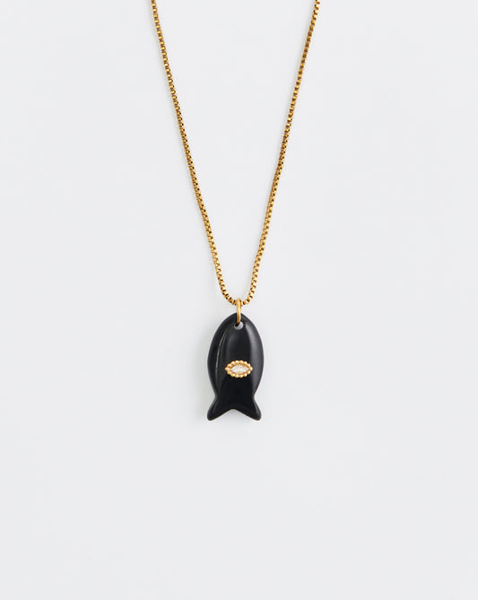 Black pendant necklace with gold chain on a white background